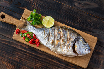 Grilled fish on the wooden board