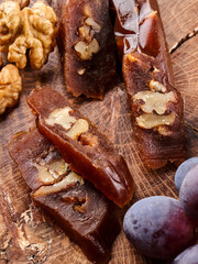 Churchkhela, national Georgian dessert made from grape juice and walnuts, composition on a wooden table