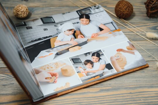 Luxury wooden photo book on natural background. Family memories photobook. Save your summer vacation memories.