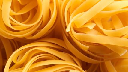 Italian egg pasta nest close-up. Fettuccine background