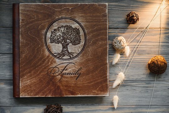 Luxury wooden photo book on natural background. Family memories photobook. Save your summer vacation memories.