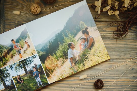 Luxury wooden photo book on natural background. Family memories photobook. Save your summer vacation memories.