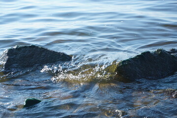 A small wave running on stones
