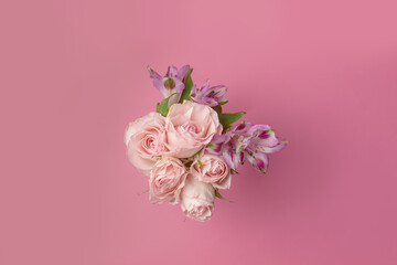 a beautiful bouquet of flowers on a pink background copy the space, the view . pink roses. the concept of love, romance