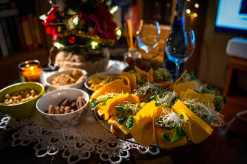 Snacks for wine on the buffet table. Cold snacks such as cookies, nuts, sandwiches with salmon and cheese and nachos. Party snacks table showing christmas or new year celebration concept
