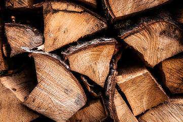 textured firewood background of chopped wood for kindling and heating the house. a woodpile with stacked firewood. the texture of the birch tree
