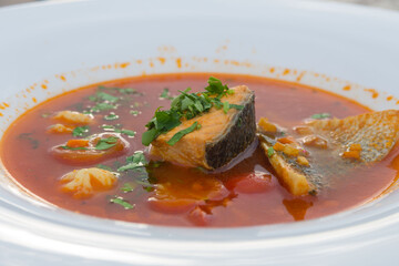 Traditional French cuisine. The famous dish of the fishermen of Marseilles Bouillabaisse soup with shrimps, mussels and fish in a white plate.