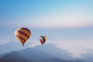Fototapeta na wymiar Hot air balloons flying over the mountain.