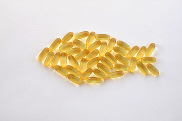 omega 3 capsules laid out in the shape of a fish
