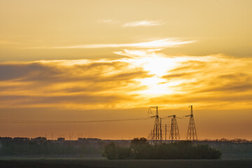 High voltage power line on industrial electricity line tower. Energy transmisson with overhead...