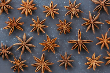 Anise stars closeup against dark rustic wooden background geometric rhythm shape