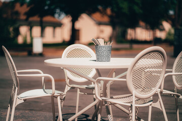 White table and chairs are on the street