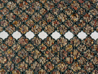 Mesh for strengthening the road surface in the car park. Small crushed stone in the cells.
