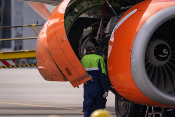 mechanic inspects the engine of the aircraft