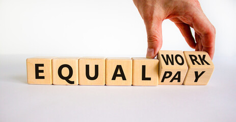 Equal pay and work symbol. Businessman turns wooden cubes and changes words equal pay to equal...