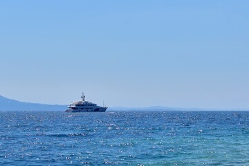 Fototapeta na wymiar Ship in the sea. Marine yacht on the border of turquoise sea and blue sky on sunny day