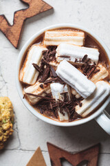 Christmas or New Year festive background. Hot chocolate or cocoa with marshmallow, cookies, christmas decorations, gray tiles background.