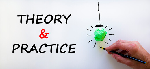 Theory and practice symbol. Businessman writing words 'Theory and practice', isolated on beautiful...
