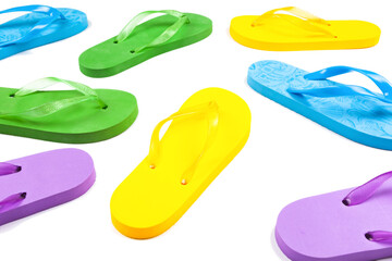 multi-colored rubber beach flip flops on a white background