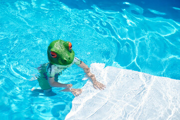 boy in frog costume on a summer day