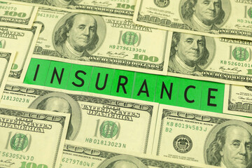 Insurance word and dollar bills on the table, business and economy concept background photo