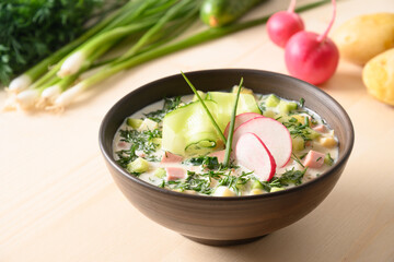 Russian summer okroshka soup with kefir. Freshness okroshka made of summer chopped vegetables, cucumber, radish, potato, boiled eggs, dill serving kefir or airan, carbonated water. Close up.