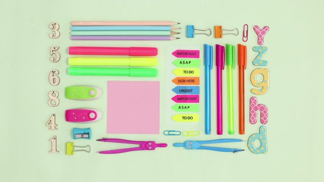 Back to school stationery making creative layout on green theme. Stop motion
