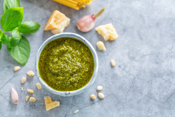 Pesto sauce in small bowl on table