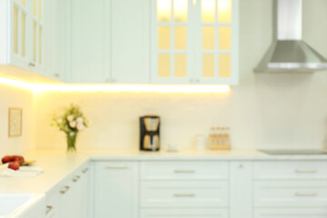 Blurred view of modern kitchen interior with stylish furniture