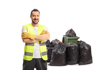 Waste collector in a uniform and gloves posing and smiling - obrazy, fototapety, plakaty
