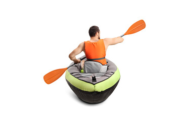 Rear view of a man in a canoe with a life vest and a paddle