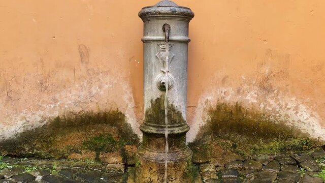 Typical fountain of Rome with a characteristic design called "nasone" (big nose) due to the metal spout that looks like a big nose. Flowing free drinking water.