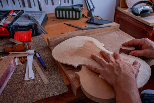 Part of process where luthier is making the body of violin 