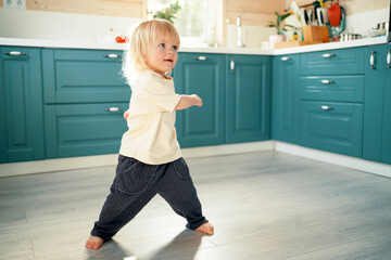 Playing at home dancing alone on the kitchen floor.