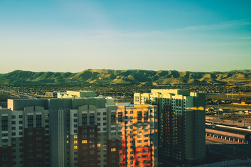 Las Vegas skyline panorama at sunset. Green mountains along horizon.