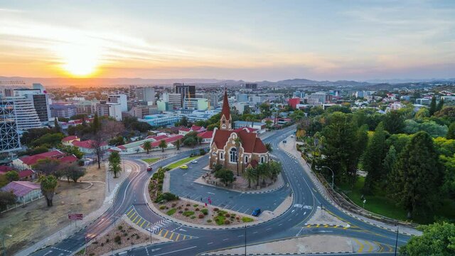 Day to night timelapse view of traffic around historic landmark Christ Church aka Christuskirche in Windhoek, the capital and largest city of Namibia.	