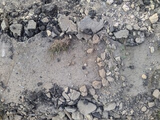 dismantled asphalt pavement and pieces of asphalt in the summer during the day.