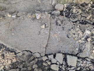 dismantled asphalt pavement and pieces of asphalt in the summer during the day.
