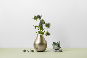 Healing green mineral ore crystals and flowers in vase