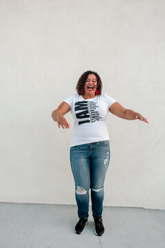 Laughing Black woman in jeans and t-shirt 