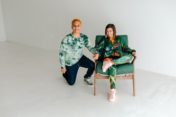 Woman in chair and partner on one knee