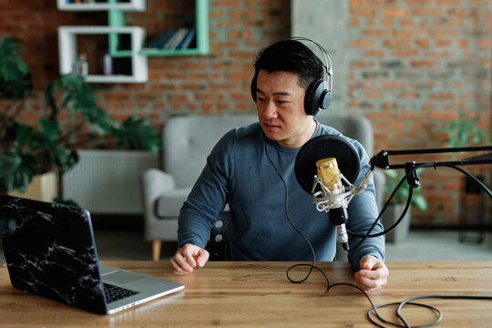 Man using laptop during podcast 
