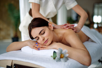 Young woman enjoying massage therapy 