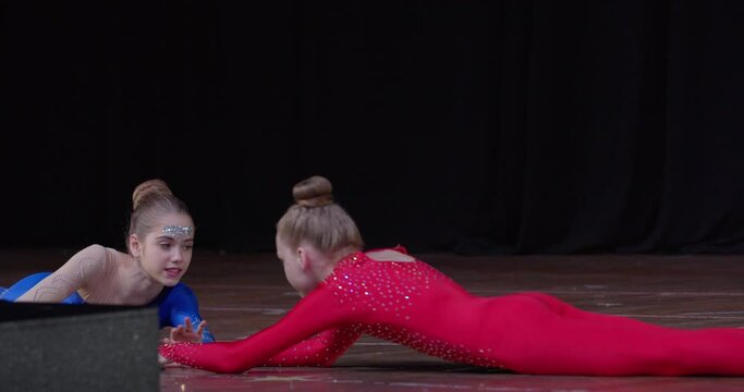 Footage of professional young athletes doing gymnastics on stage, sports, 4k
