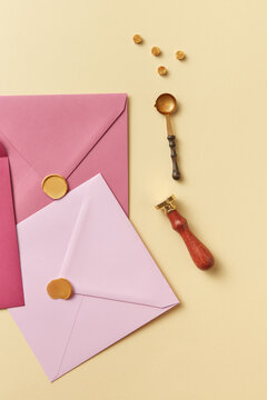 Pink envelopes for letters and wax beads