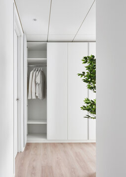 Wardrobe with clothes in light room