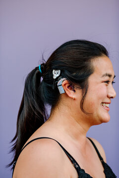 Woman with silver cochlear implant skins