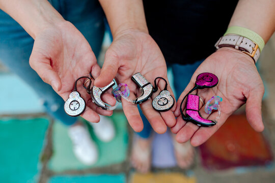 Hands holding cochlear implants 