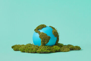 Earth globe on green moss