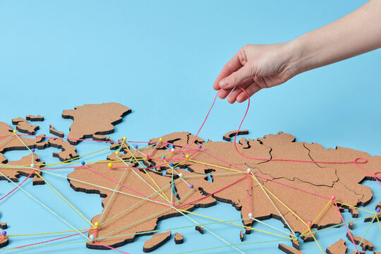 Woman holding thread above map with connections